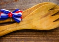 Close-up of Large Wooden Serving Fork and Spoon with red, white, and blue bow. Royalty Free Stock Photo